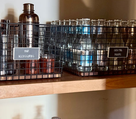 Bar tools and mixers organized in Neat Method wire baskets by KO Luxury Organizing in Snowmass, CO