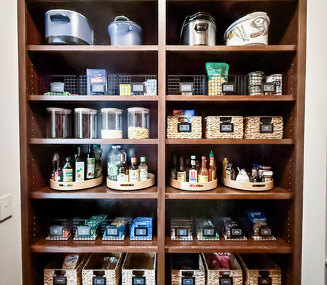 Pantry shelving organized with labeled bins, canisters, turntables, and large crates by KO Luxury Organizing in Greenwood Village, CO