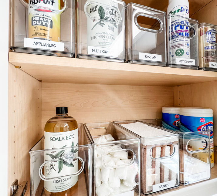 Cleaning supplies organized in The Home Edit clear pantry bins with white labels done by KO Luxury Organizing in Cherry Hills Village, CO.