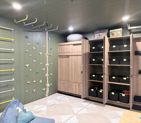 Kids' playroom organized with built-in cabinetry and labeled Sort Joy storage bins by KO Luxury Organizing in Aspen, CO
