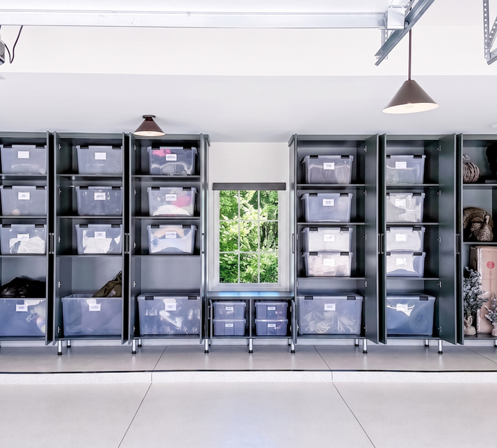 Floor-to-ceiling dark green garage cabinets with labeled clear storage bins organizing seasonal items and gear — organized by KO Luxury Organizing in Cherry Hills Village, CO.