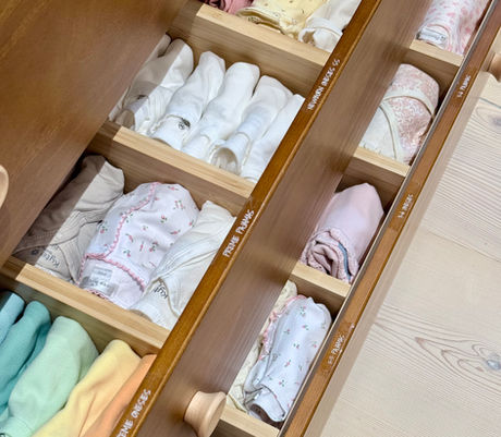 Baby clothes organized in changing table drawers with drawer dividers and size labels, by KO Luxury Organizing in Snowmass, CO