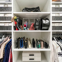 Bags and accessories organized in a closet with various organizing solutions