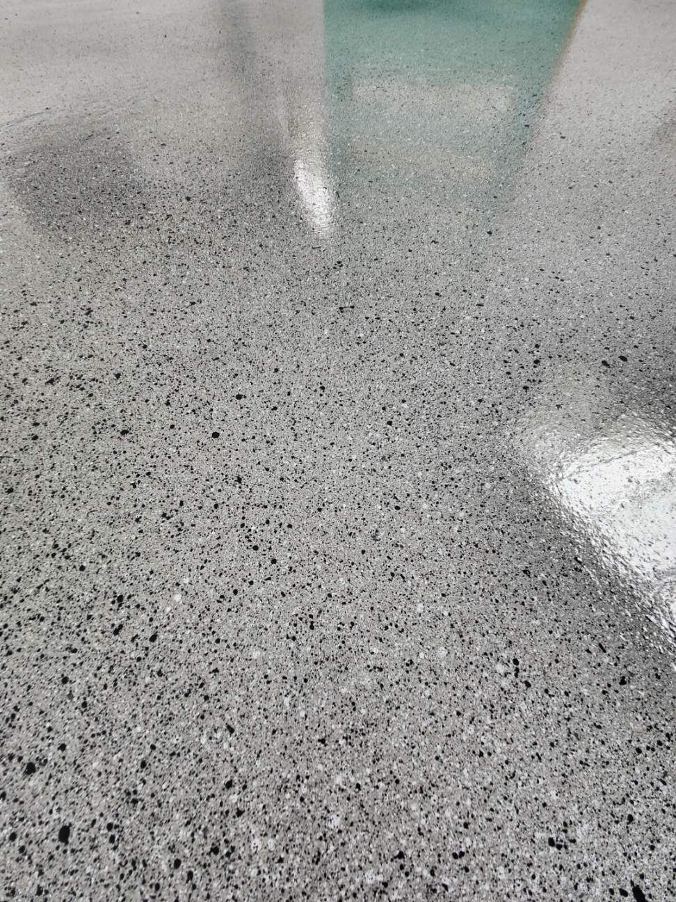 Concrete floor with epoxy in a stipple stone finish.