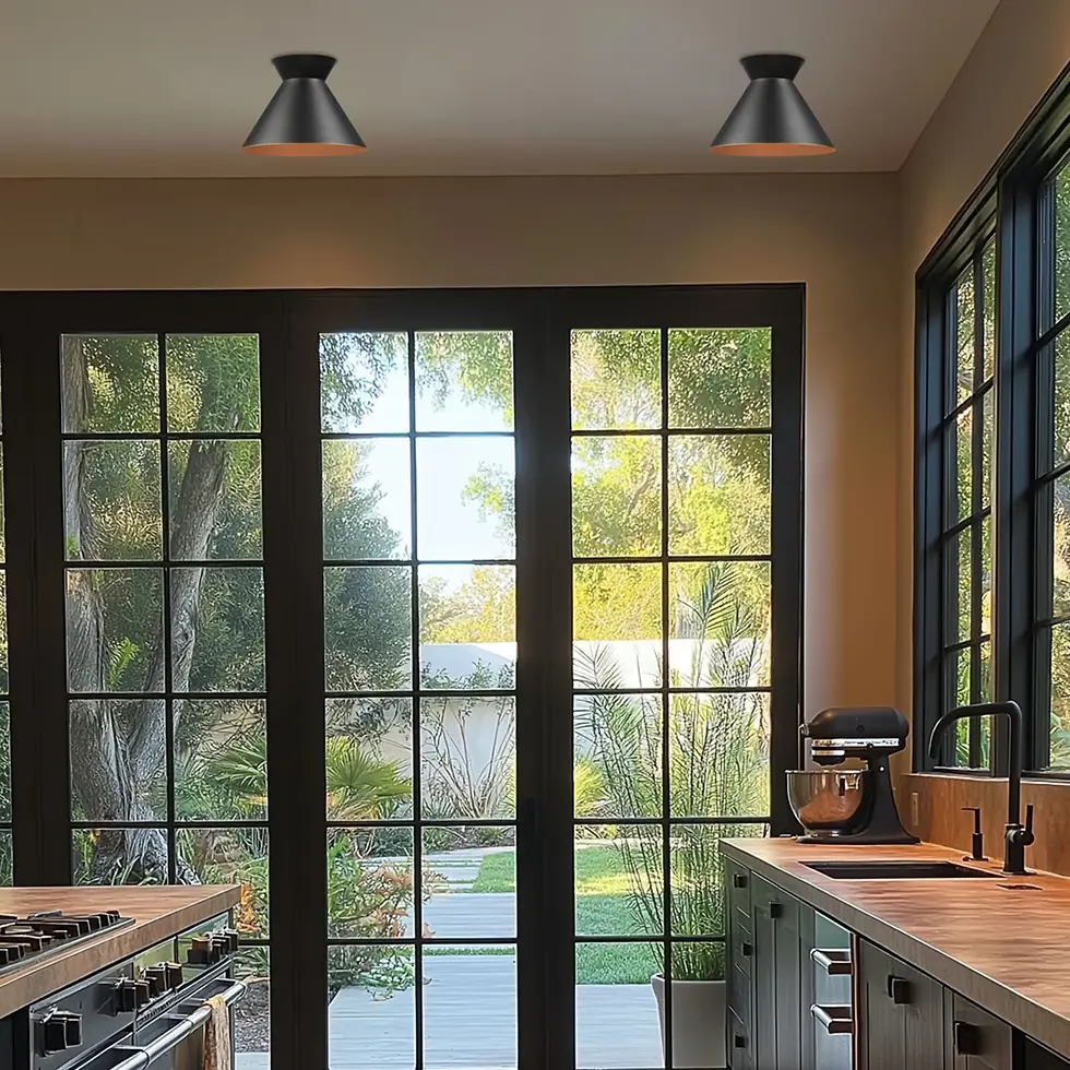 Two black cone flush mount lights installed on a white ceiling in a modern kitchen with large windows.