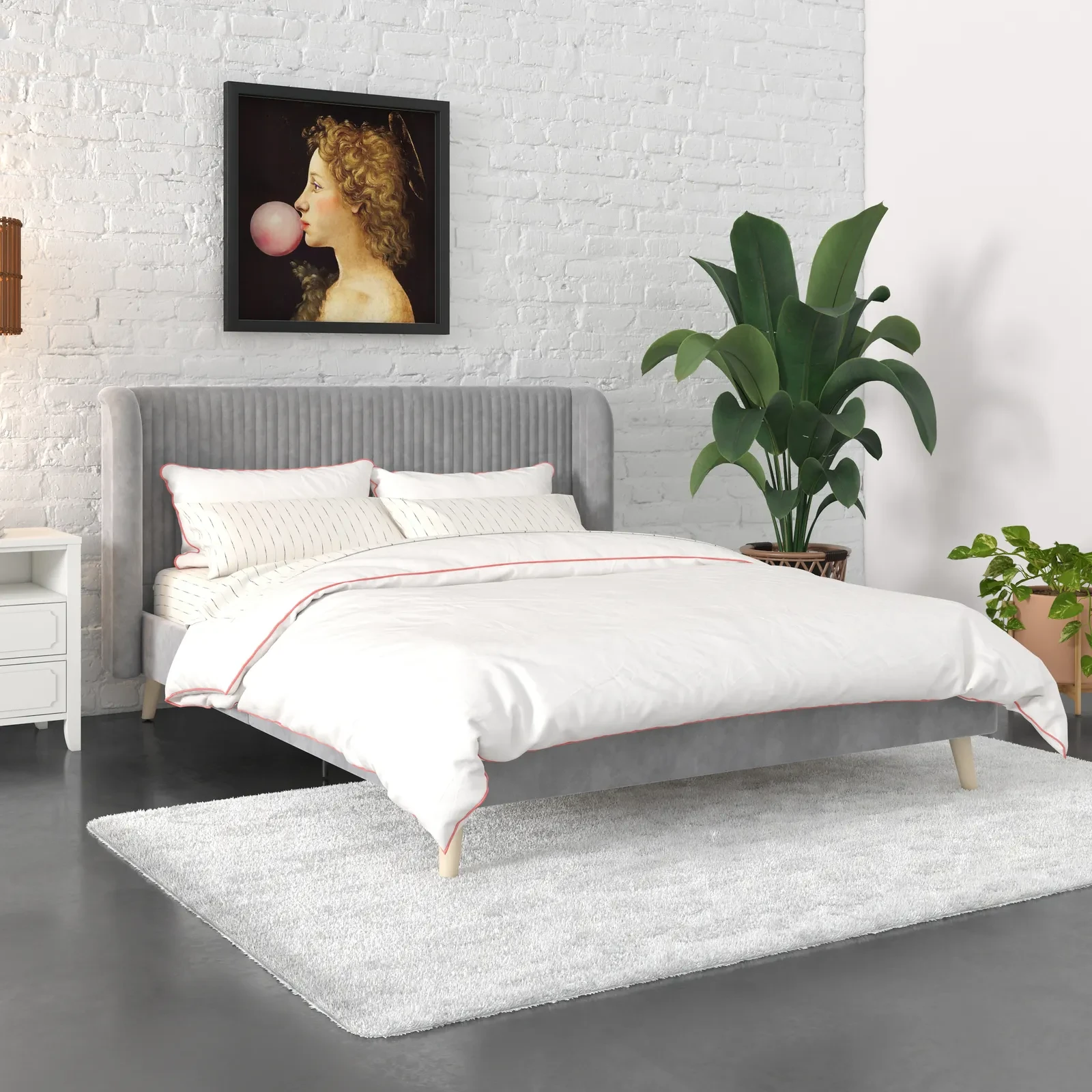Bed with matching gray bedding and plant in room