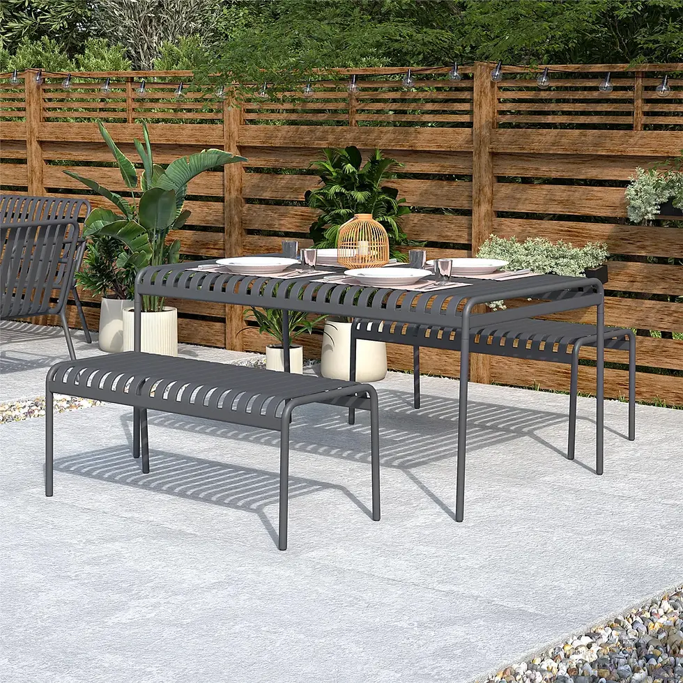 Outdoor patio setting featuring the gray metal dining table and benches arranged for a meal on a stone patio.