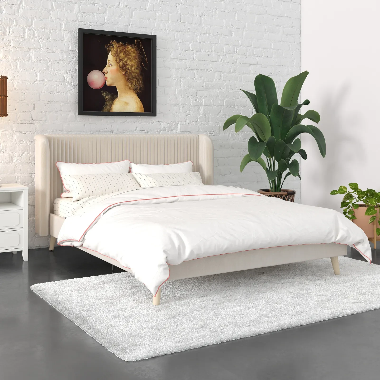 White bed against white brick wall with framed artwork above