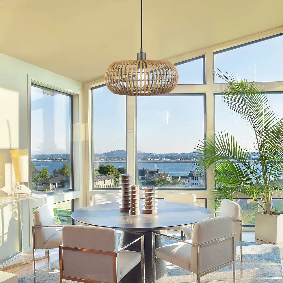 Rattan pendant light with dome-shaped woven shade suspended above a modern dining area with panoramic windows.