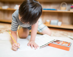 young boy learning how to write