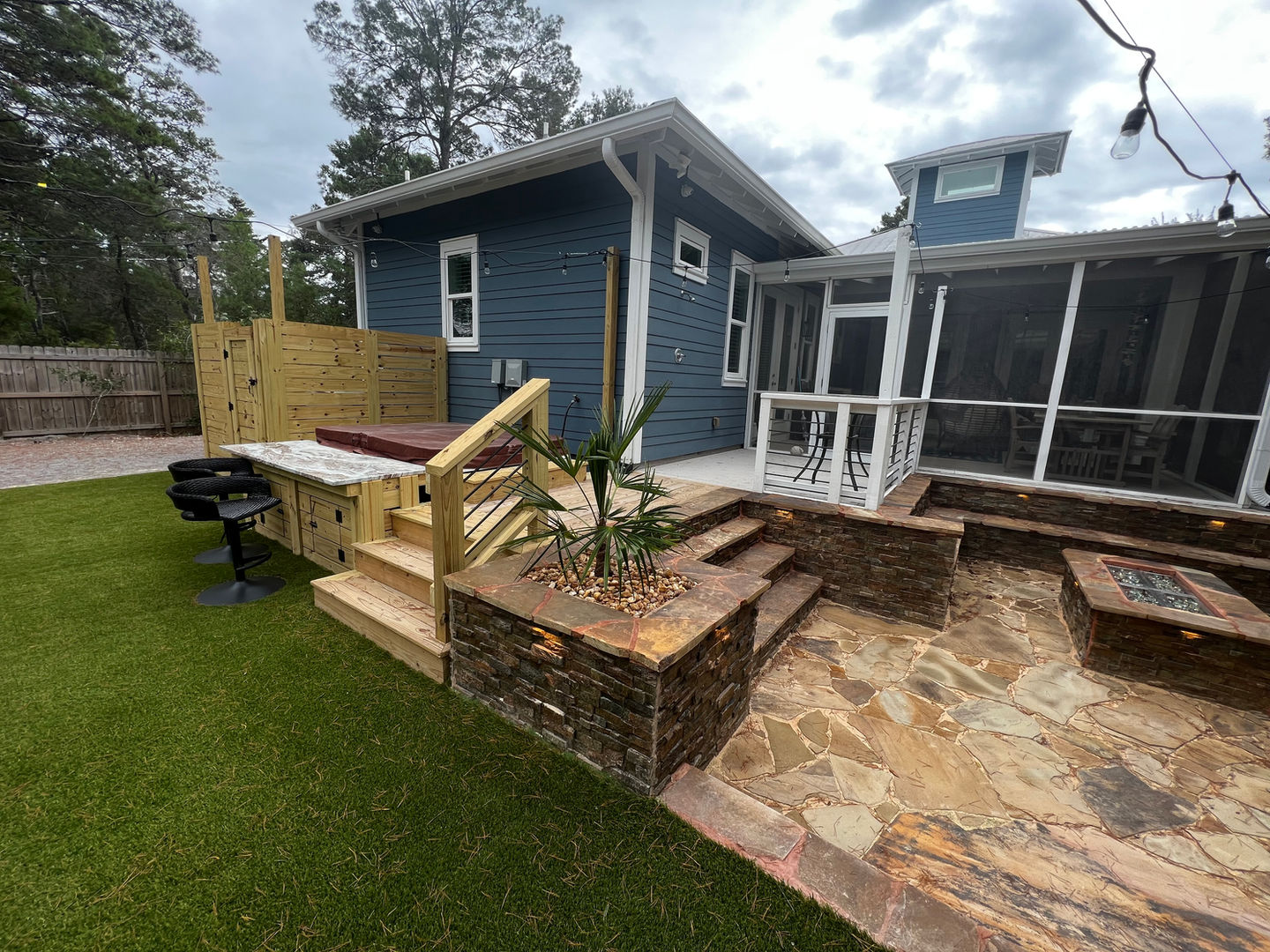 Luxury landscaping with sod, irrigation, artificial turf, pavers, and outdoor living by Turf Tailors in Santa Rosa Beach.