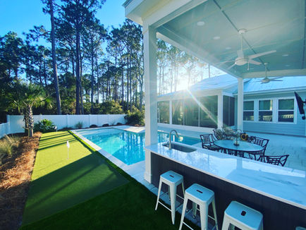 Luxury landscaping with sod, irrigation, artificial turf, pavers, and outdoor living by Turf Tailors in Fort Walton Beach.