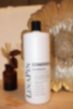 White Linapin Conditioner bottle with visible text on a decorative background.