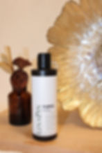 LinaPin Purple Shampoo bottle on a wooden surface with a golden backdrop.