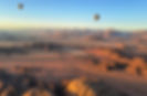 2 hot air balloons floating over the wadi rum desert during sunrise