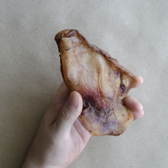 man-holding-dried-pork-ear.jpg