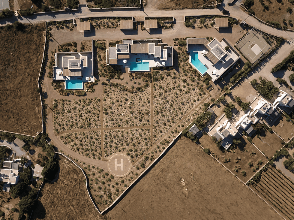 Aerial view of TREĪS Luxury Estate in Isterni Paros, with the Mediterranean garden, the basketball court and the helipad