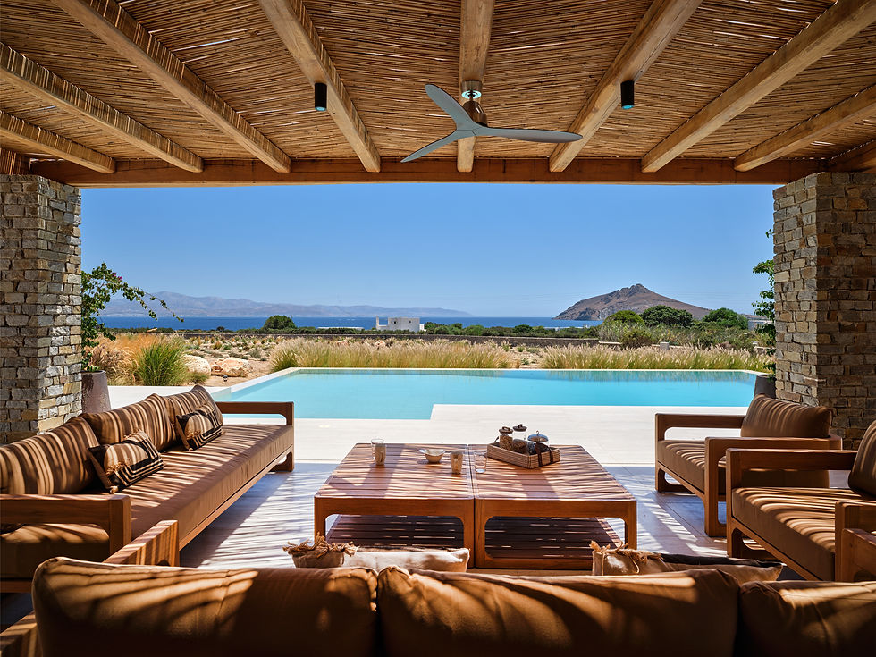 Eye-level view of a whitewashed villa terrace overlooking the Aegean Sea