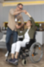 full-shot-smiley-woman-sitting-wheelchair-min.jpg