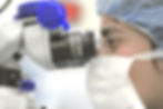 Scientist using microscope
