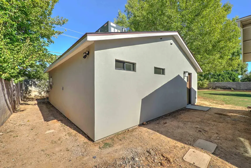 Exterior guest house front entry with dirt landscaping