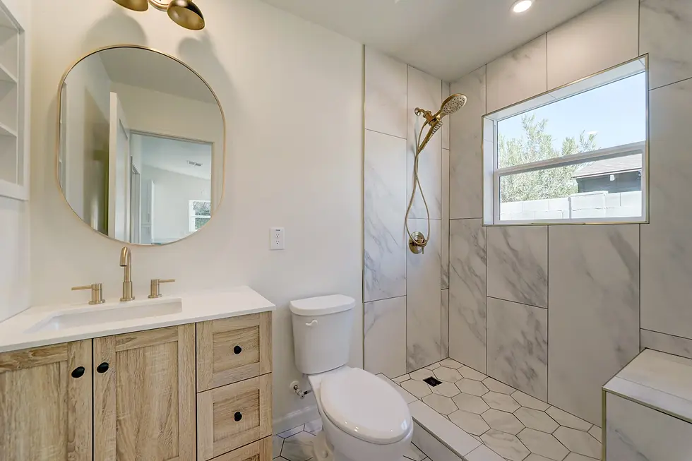 Bathroom with vanity, mirror, toilet, and shower in a 1 bed 1 bath casita