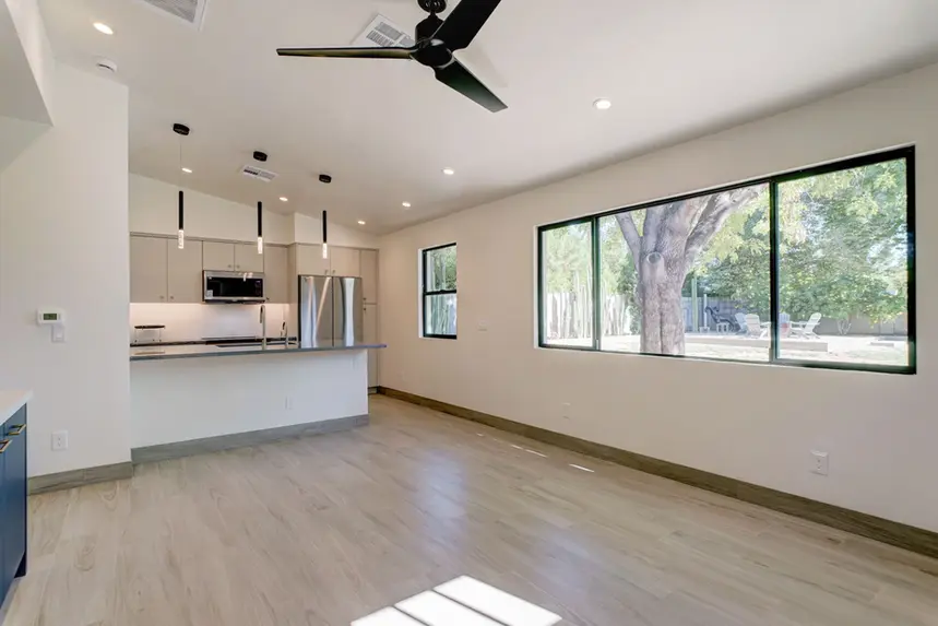 Interior guest house front entry living room view with energy efficient windows and kitchen