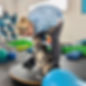 A french bull dog gets kisses during exercises on a wobble board with a registered veterinary technician