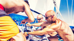 Action on deck as the catamaran cuts through turquoise waves