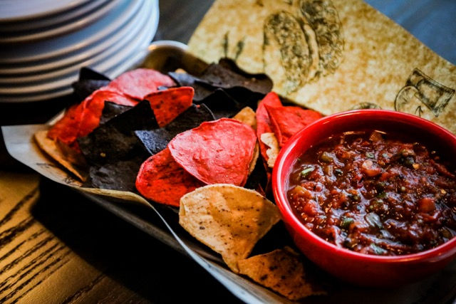Vibrant red and blue corn tortilla chips served with a side of chunky house-made salsa at Resorts World Catskills.