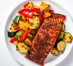 Baked salmon with a chili-lime rub and a side of grilled vegetables