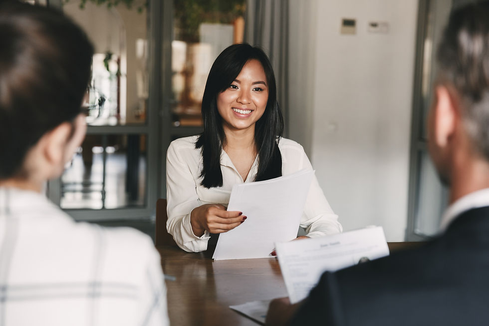 young asian woman smiling and holding resume.jpeg