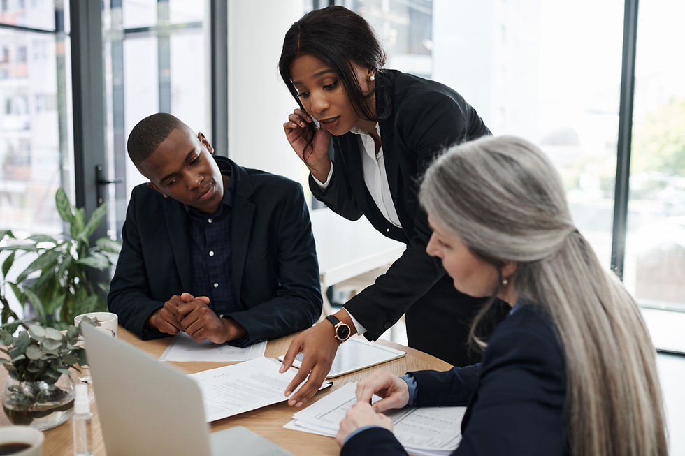 Three team members discussing data in a meeting