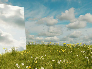 Mirror reflecting clouds in a field