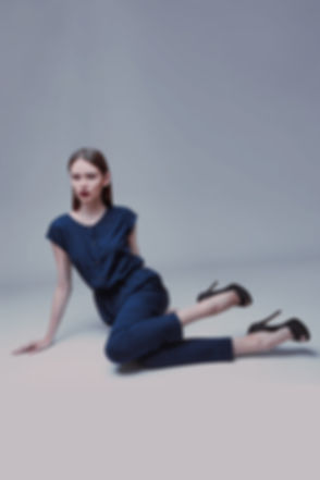 Model in blue silk jumpsuit