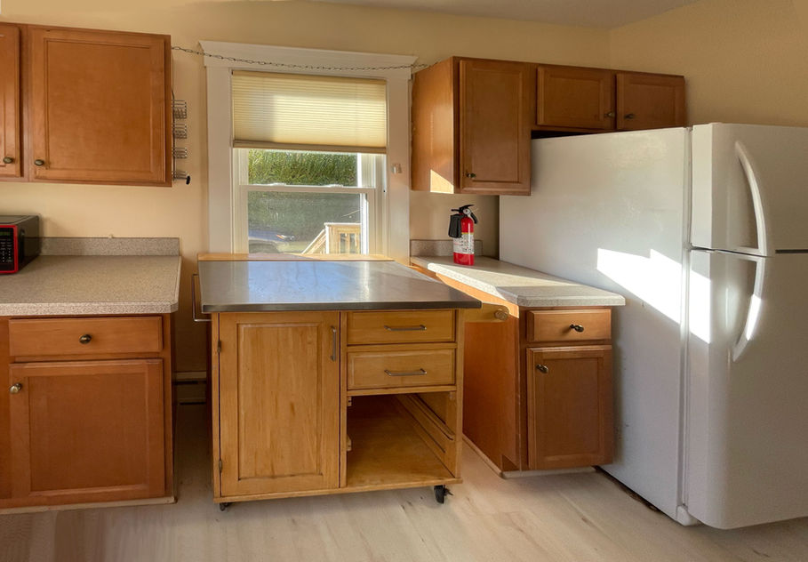 Original kitchen with low window sill and cramped layout.