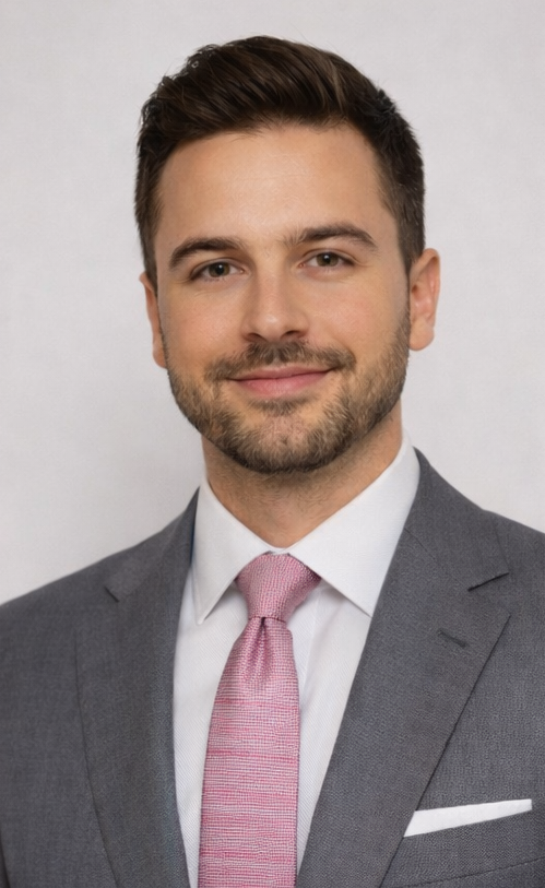 Professional man in a gray suit and pink tie smiling