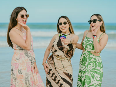 Three best friends celebrating a 34th birthday photoshoot in Macao Beach Punta Cana with colorful number candles and Caribbean ocean in the Dominican Republic