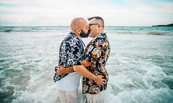 una pareja same sex besandose y abrazandose en el mar de Macao Punta Cana mientras tomaba foto Magda, fotografa profesional