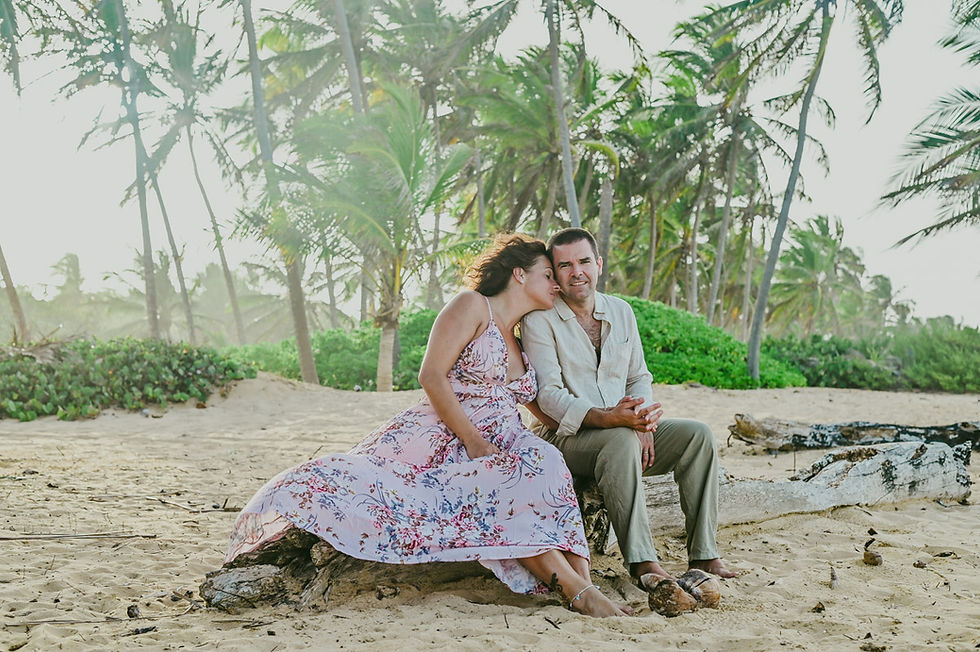 Romantic couple portrait among the palm trees of Uvero Alto Beach at sunset