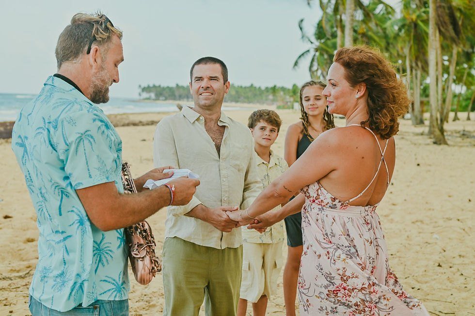 Exchanging wedding rings during a beachfront vow renewal ceremony in the Caribbean