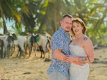 tattooed couple embracing with horses in the background on the beach during a post wedding photoshoot near Excellence Punta Cana Uvero Alto Dominican Republic