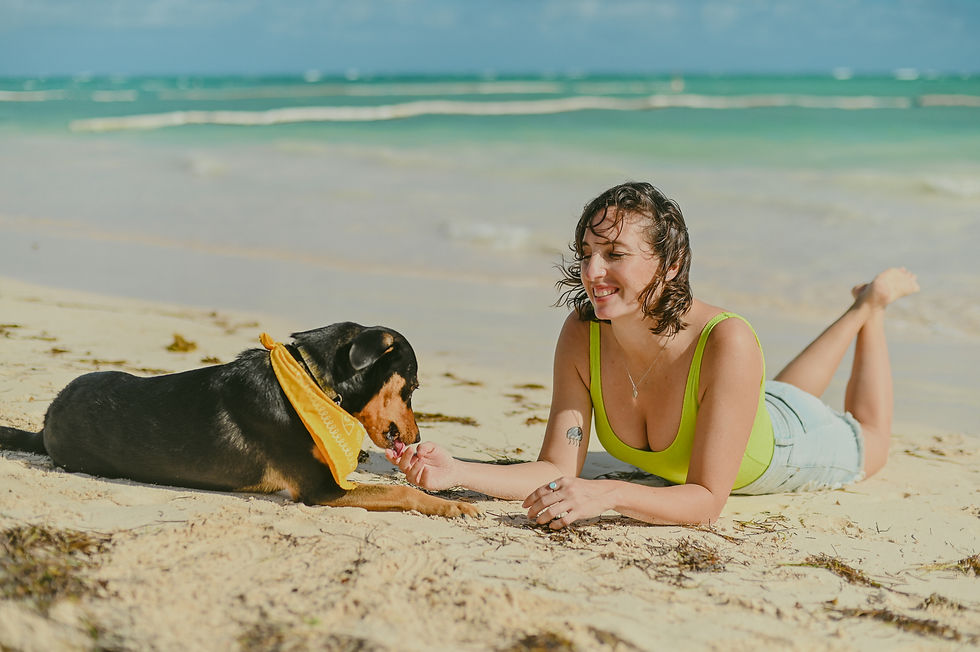 A woman and her three-legged pet bond on Bavaro Beach between Jellyfish Restaurant and Kukua Beach Club.