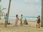 Family celebrating their 25th wedding anniversary with a vow renewal ceremony on Uvero Alto Beach in Punta Cana