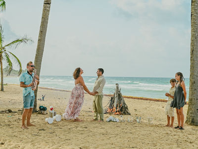 Family celebrating their 25th wedding anniversary with a vow renewal ceremony on Uvero Alto Beach in Punta Cana
