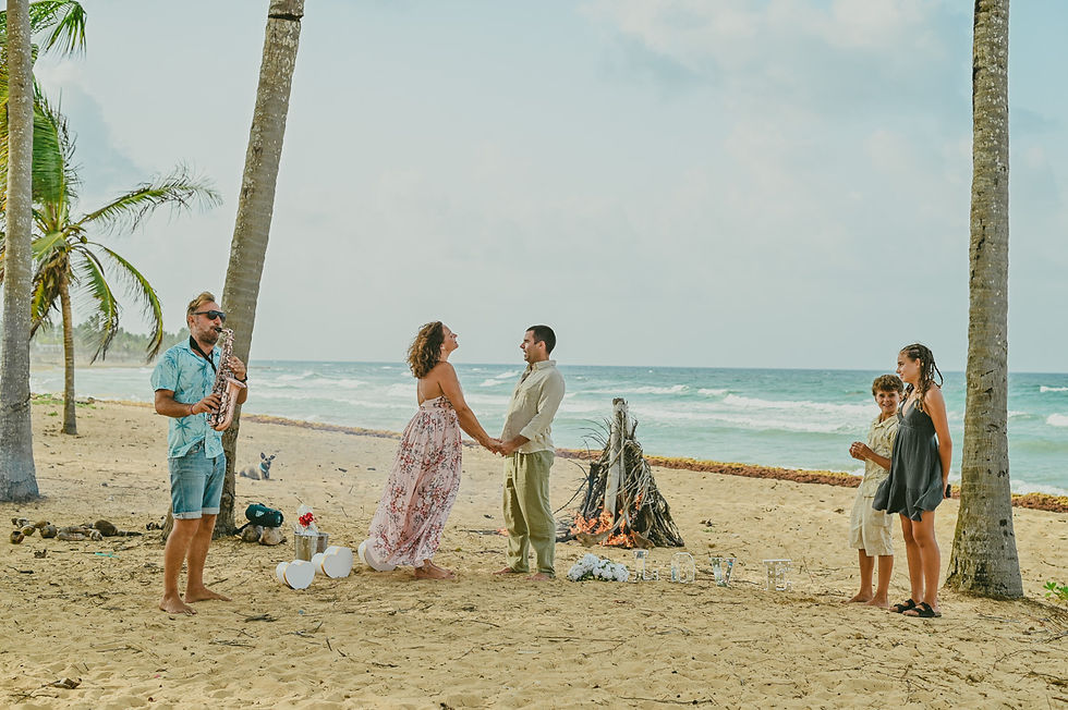 Family celebrating their 25th wedding anniversary with a vow renewal ceremony on Uvero Alto Beach in Punta Cana
