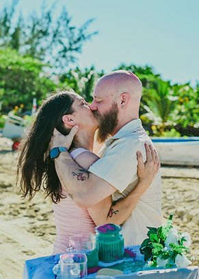 Ashley and Wes kissing during their surprise vow renewal at Macao Beach, Punta Cana