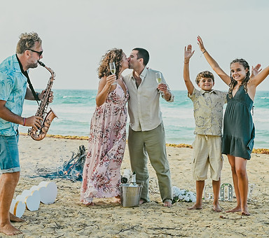 Family celebrating a 25th wedding anniversary with a vow renewal ceremony on Uvero Alto Beach in Punta Cana