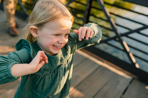 girl running on a bridge in the sunshine