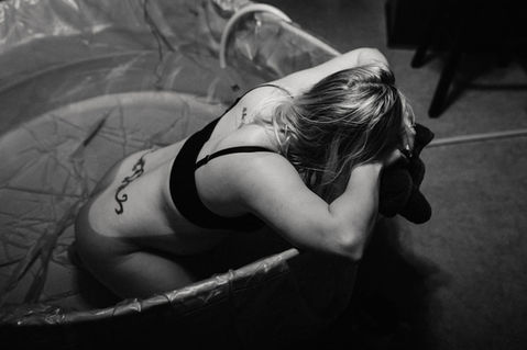 woman laboring in birthing tub at home